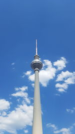 Low angle view of tower against blue sky