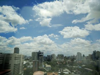 Modern buildings against cloudy sky