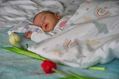 High angle view of cute baby sleeping on bed