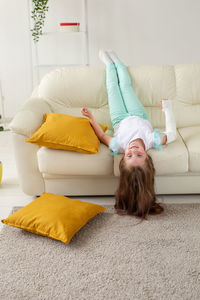 Girl lying on sofa at home
