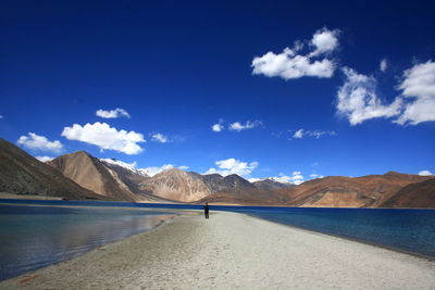 Scenic view of mountains against blue sky