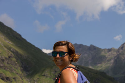 Portrait of smiling woman against sky