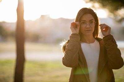 Portrait of young woman standing outdoors