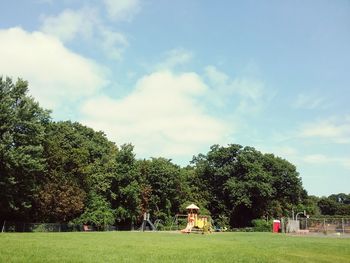 Trees and grass against sky