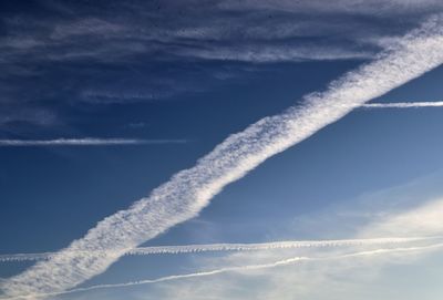 Low angle view of vapor trails in sky