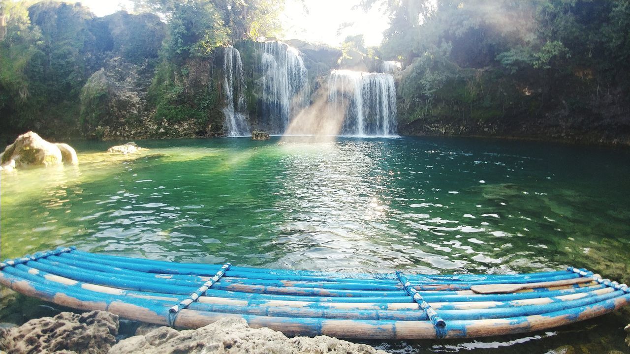 SCENIC VIEW OF WATERFALL IN LAKE