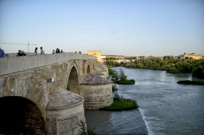 View of bridge over river against clear sky