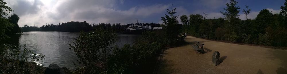 Panoramic shot of silhouette trees by calm lake