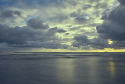 Scenic view of sea against storm clouds