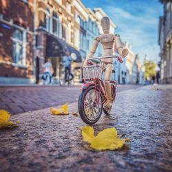 Bicycle parked on street against buildings