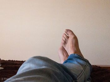 Low section of man relaxing on floor