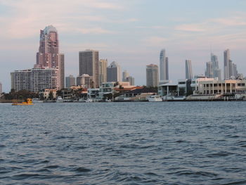 Sea and cityscape against sky