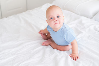 Close-up of cute baby boy sleeping on bed at home