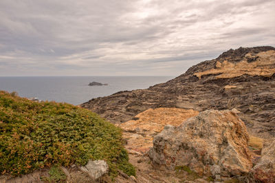 Scenic view of sea and mountains against sky