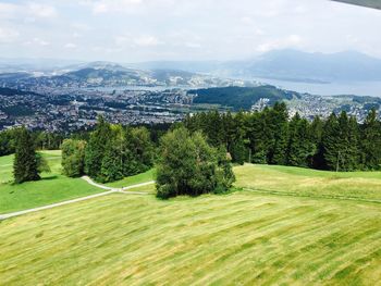 Scenic view of green landscape against sky