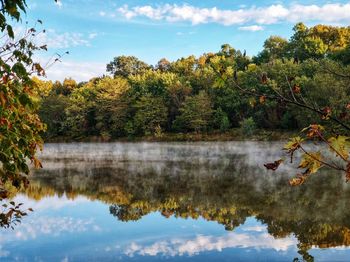 Reflection of trees in lake against sky during autumn