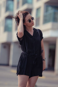 Young woman wearing sunglasses standing outdoors