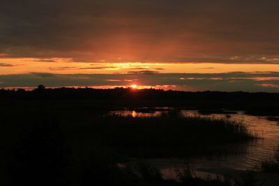 Scenic view of lake against sky during sunset