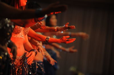 People in traditional clothing performing on stage during event