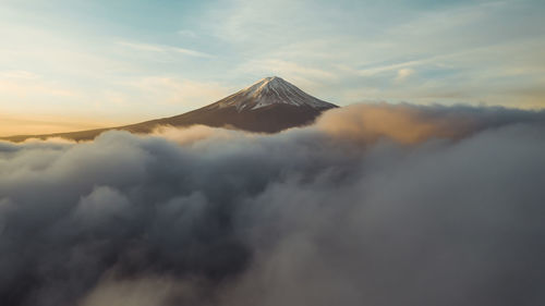 Scenic view of majestic mountains against sky during sunset