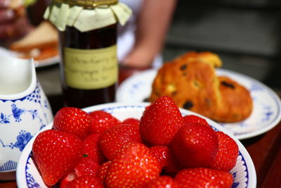 Close-up of strawberries and scones on table