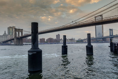 View of suspension bridge in city at sunset