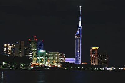 Low angle view of skyscrapers lit up at night