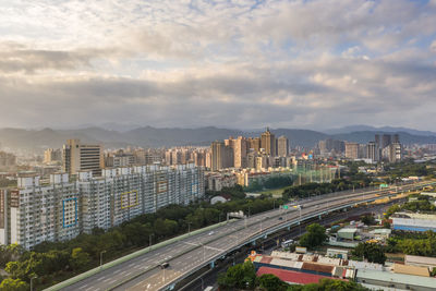 High angle view of street amidst buildings against sky