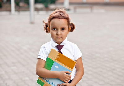 Portrait of young woman standing in city