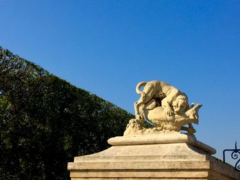 Low angle view of statue against clear blue sky