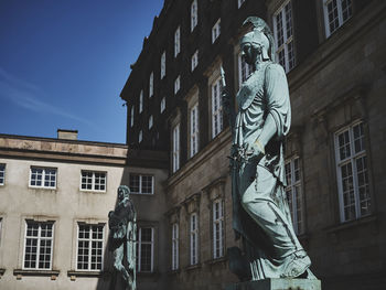 Low angle view of statue against building