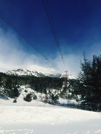 Close-up of ski lift against sky