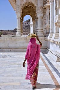 Rear view of woman walking in temple