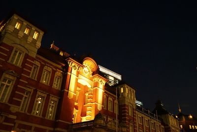 Low angle view of illuminated buildings against sky