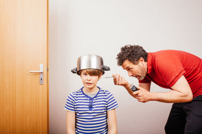 Father and son standing in room