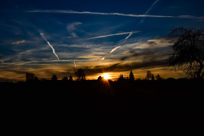 Silhouette landscape against sky during sunset