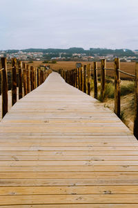 View of wooden boardwalk leading towards landscape