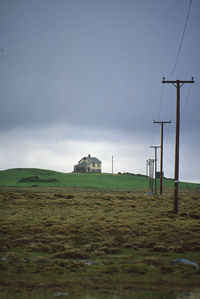 Built structure on field against sky