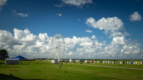 Scenic view of field against cloudy sky