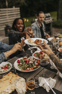 Friends having meal in garden