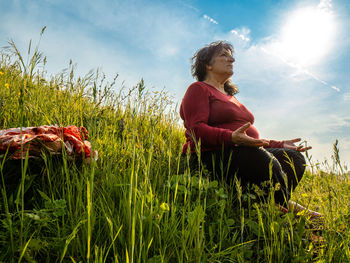 Senior lady meditating in nature