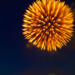 Low angle view of firework display at night