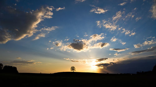 Scenic view of silhouette land against sky during sunset