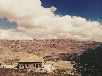 Scenic view of landscape against cloudy sky