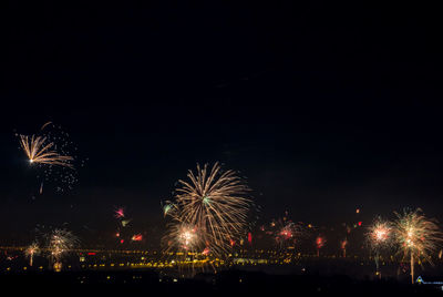 Low angle view of firework display at night