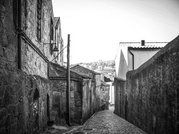 Narrow alley amidst buildings against sky