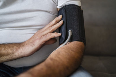 Man examining blood pressure at home