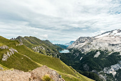 Panoramic view of lake fedaia and the marmolada glacier.