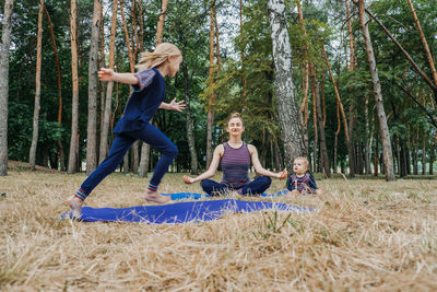 Parents and mental health. parents zen. little preschool daughter jumping while her mother doing