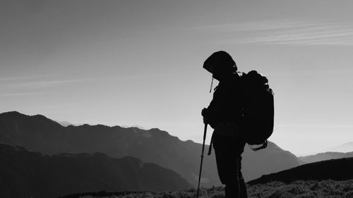 Man standing on mountain against sky